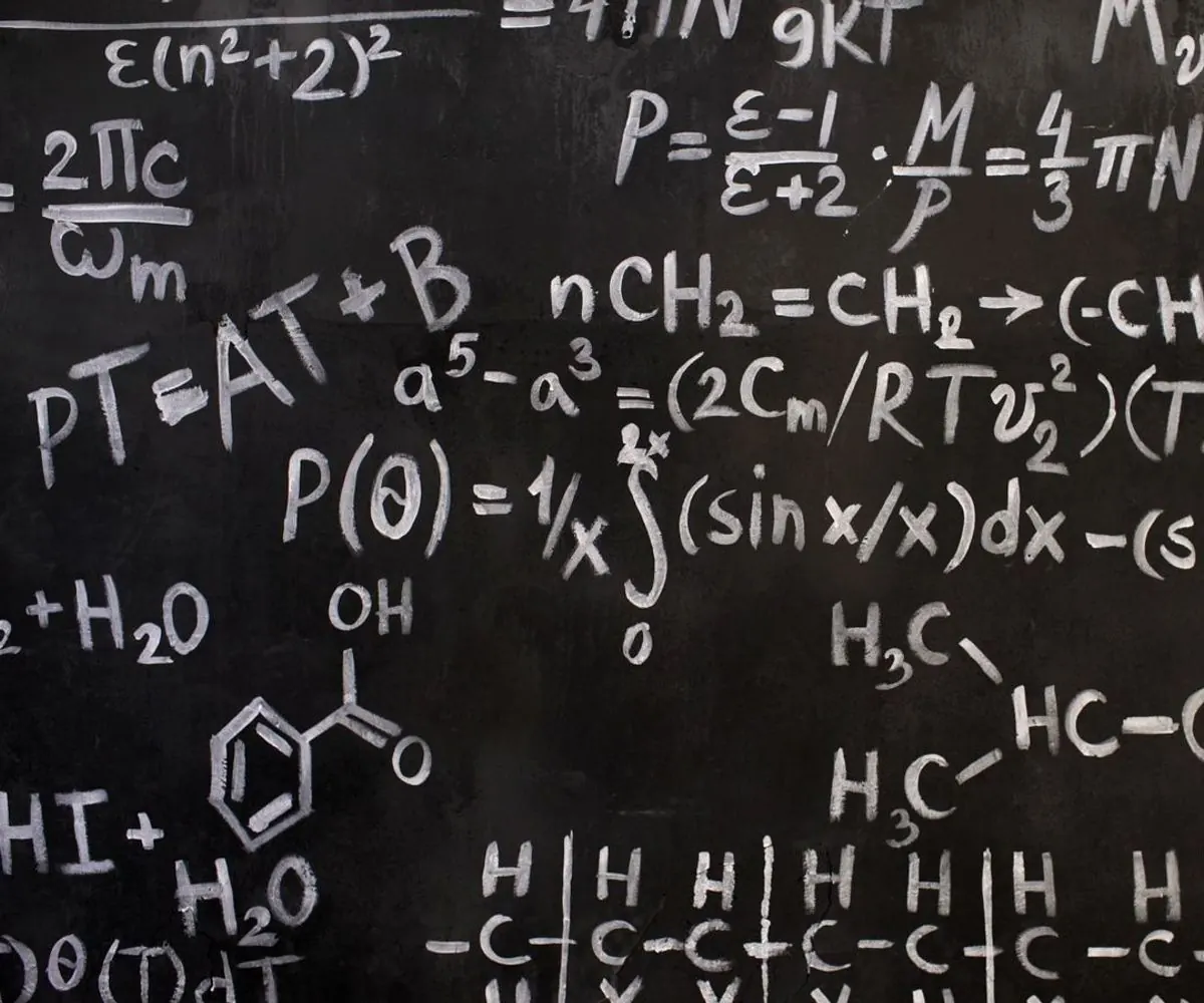 A corner of a blackboard covered in chemical notation.