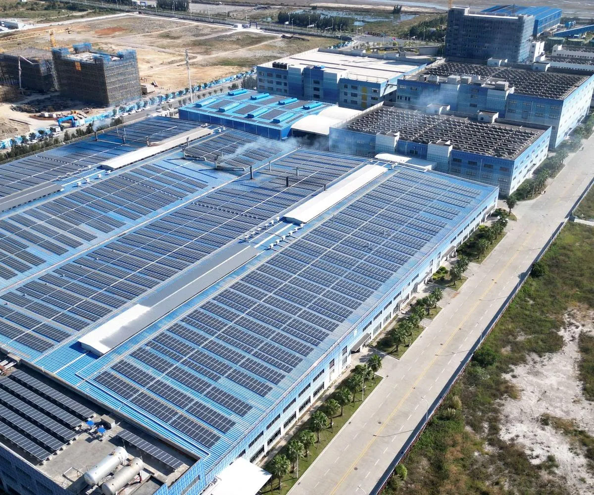 An industrial roof covered end to end with solar arrays, seen from the air.