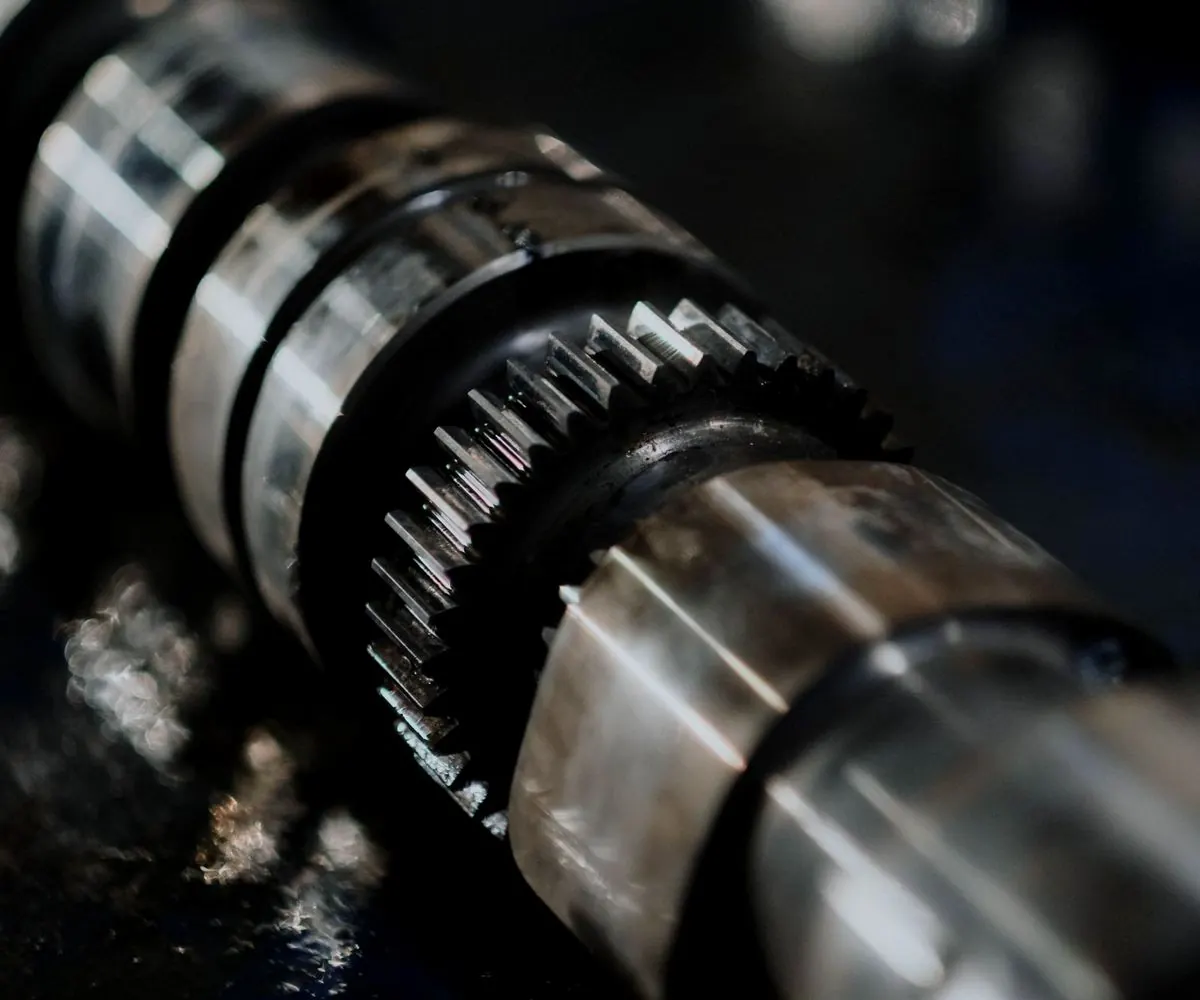 An engine camshaft photographed close along its length.